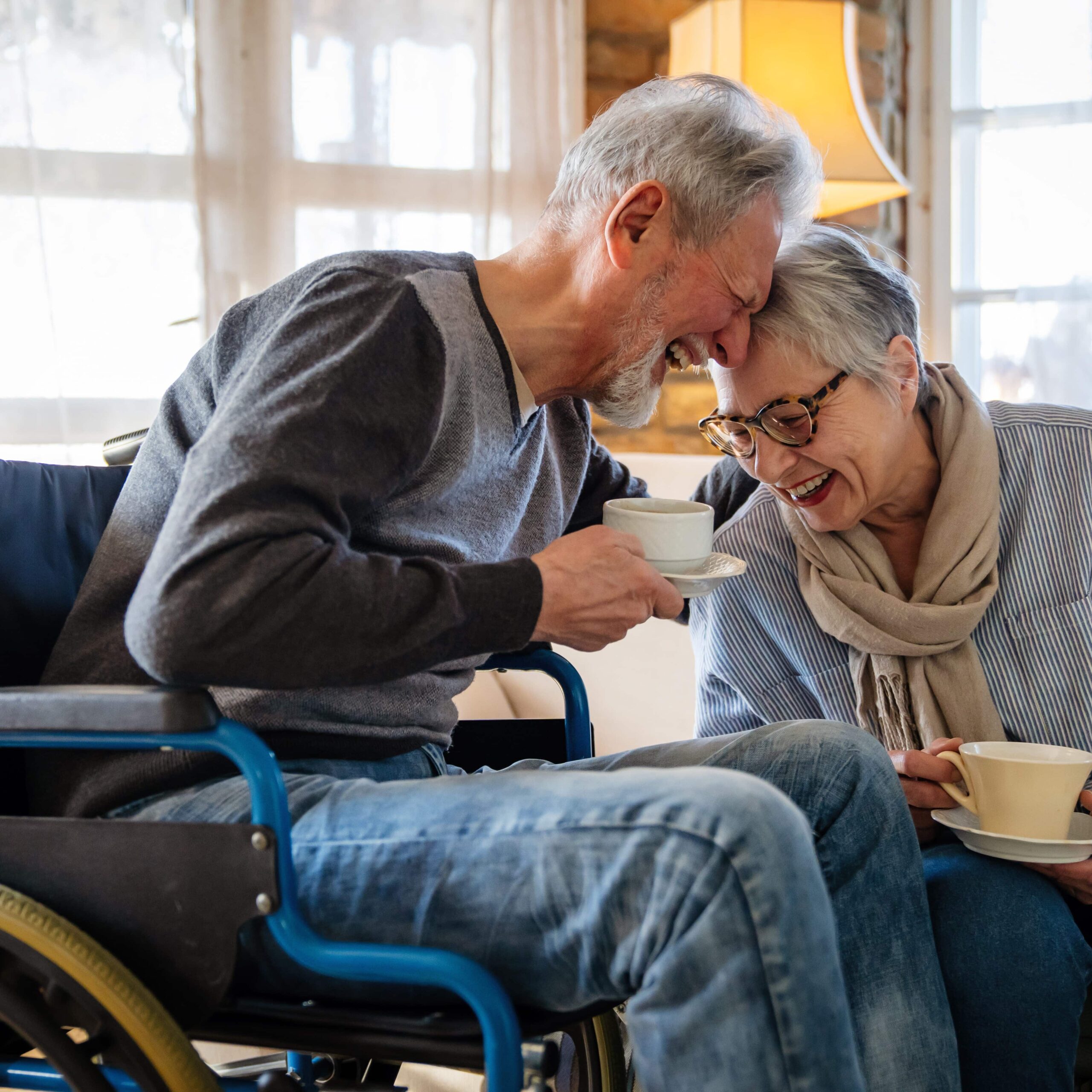 Man in wheelchair with his wife laughing